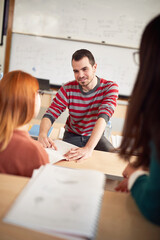 Naklejka premium Male colleague helping female classmate