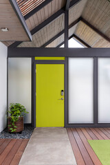 Front door, yellow front door with black trim and white walls