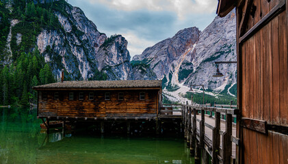 Amazing view of Lake Braies with a wooden hut and reflection on the water, surrounded by the Dolomites. Trentino Alto Adige, Italy.
