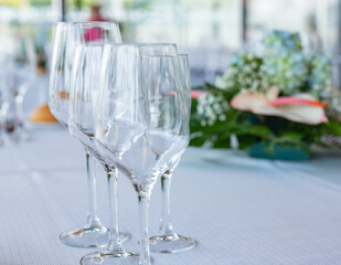Empty crystal or glass cups on a tablecloth