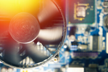CPU cooler of processor on motherboard. Computer circuit board and CPU spinning cooling fans inside...