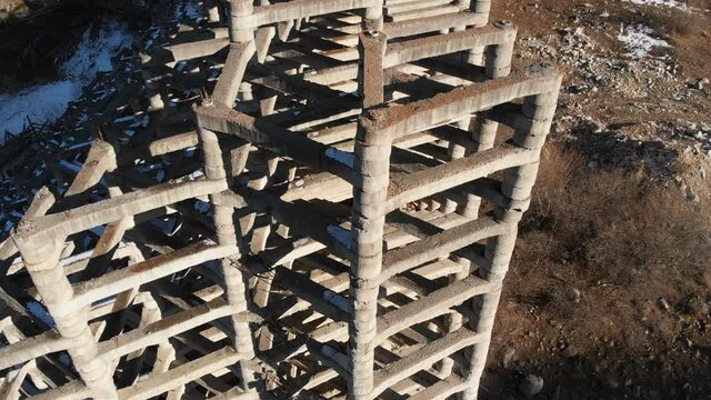 Aerial view protection against mudflow barrier in a gorge in the mountains. Reinforced concrete structure to prevent destruction by natural disaster. Powerful water and mud protection