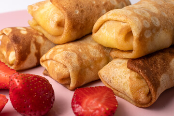 Wheat flour pancakes with strawberries. Sweet homemade pastries for breakfast. With sugar.