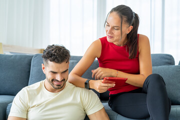 Obraz premium caucasian young businessman having social distancing meeting by video call conferfence from his notebook work from home with his attractive girlfriend