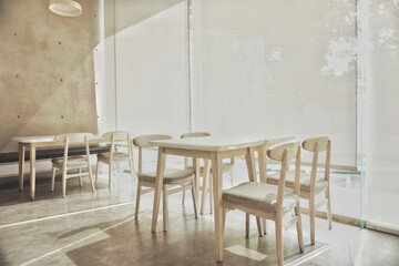 Coffee shop interior with tables and chairs in minimalist concept interior. Aesthetic composition. 