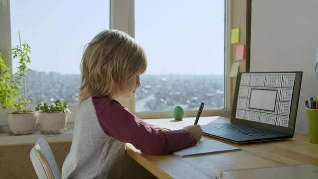 Child learning online by conference call using laptop. Boy talking and studing. Screen with optional corner pin markers for screen replacement. Education at home concept. 60fps
