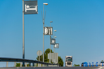 Truck entering a service area, with hotel, restaurant and store