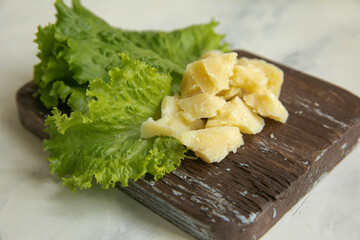 Parmesan cheese with salad leaves on a wooden base for breakfast
Very tasty and appetizing photo for the interior in the dining room or in a cafe for wall design