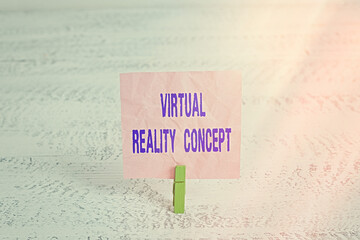 Handwriting text Virtual Reality Concept. Conceptual photo 3d futuristic artificial environment using a digital screen Green clothespin white wood background colored paper reminder office supply