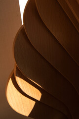 Shadows across stacked wooden chairs