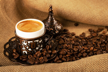 Turkish coffee. Copper cup with traditional oriental patterns of demitasse, oriental sweets rahat lokum