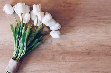 Beautiful tulips on rustic wooden background.