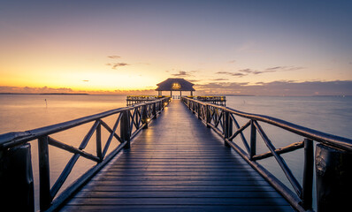 Obraz premium Off shore jetty and bar area at sunrise on pier