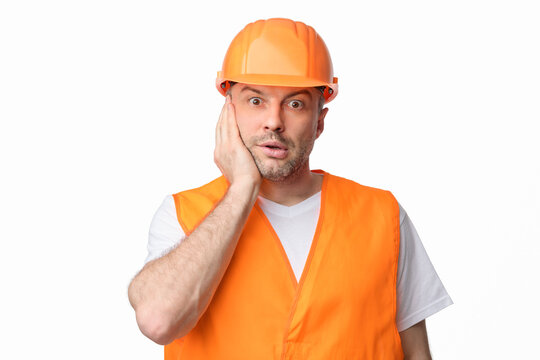 Confused Construction Worker Touching Face Posing Over White Studio Background