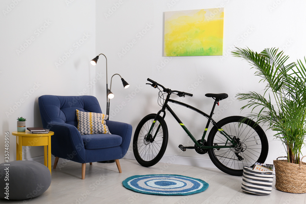 Sticker Modern bicycle and comfortable armchair in stylish living room interior