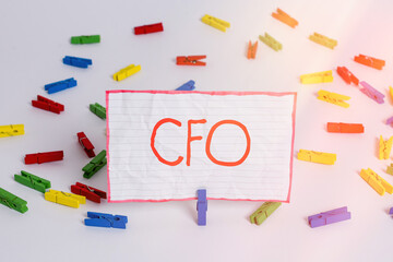 Conceptual hand writing showing Cfo. Concept meaning chief financial officer managing the financial actions of company Colored clothespin papers empty reminder white floor office