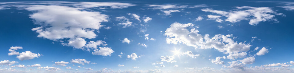 blue sky with sun and beautiful fluffy clouds. Seamless hdri panorama 360 degrees angle view without ground for use in 3d graphics or game development as sky dome or edit drone shot