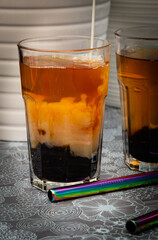 Bubble tea. Tapioka pearls in tea. Milk pouring in to the mix