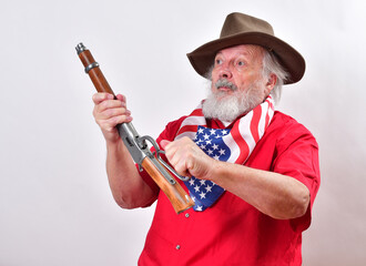 Crazy old man armed with a sawed off rifle, wearing patriotic colors, and a floppy western hat... - obrazy, fototapety, plakaty