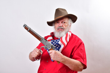 Angry old man, armed with a sawed off rifle, wearing patriotic colors, and a floppy western hat cocking his Mare's Leg weapon. - obrazy, fototapety, plakaty
