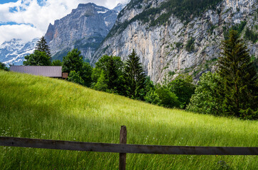 View of Lauterbrunnen valley, the Staubbachfall, and the Lauterbrunnen Wall in Swiss Alps, Switzerland.