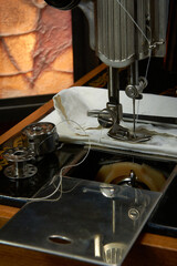 Sewing machine and parts on a dark background.