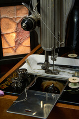 Sewing machine and parts on a dark background.