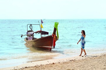 Fototapeta na wymiar woman on thailand beach with boat