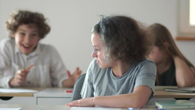 Children to the class behave impolitely, throw papers and hooligans and play pranks. Back to school, teens during class break