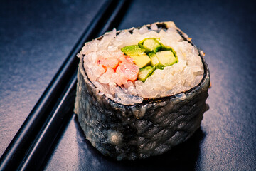 Macro of sushi served on black with reflection