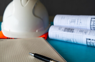Construction Blue print and white hard hat, construction engineering concept