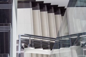 The staircase of the office building and a fragment of the glass elevator shaft.