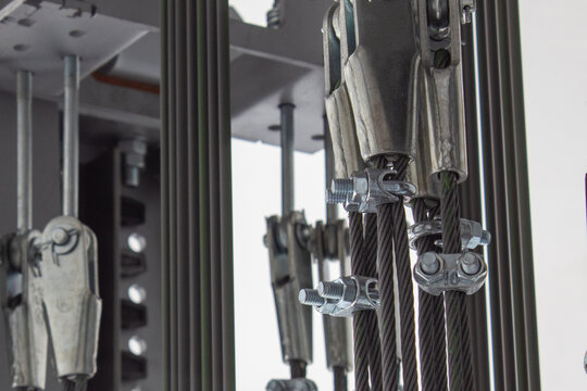 Elements of fastening steel cables in the glass shaft of the elevator.