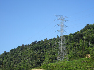 SEREMBAN, MALAYSIA -JUNE 18, 2019: High tension galvanized iron pylon tower transmitting high voltage electrical power to the consumer. 