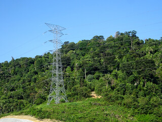 SEREMBAN, MALAYSIA -JUNE 18, 2019: High tension galvanized iron pylon tower transmitting high voltage electrical power to the consumer. 