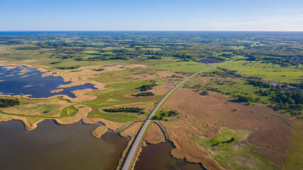 Beautiful panoramic aerial view photo from flying drone to Väinatamma is the largest access road in Estonia. This road connects Muhu Island and Saaremaa Island. (Series)