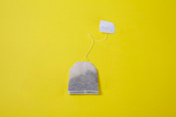 yellow background Paper tea bag with blank label