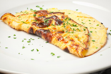 omelet with herbs in a white plate.