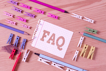 Writing note showing Faq. Business concept for list of frequently asked questions and answers on a...