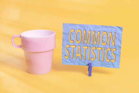 Handwriting text Common Statistics. Conceptual photo deals with collection analysis etc of numerical data Cup empty paper blue clothespin rectangle shaped reminder yellow office