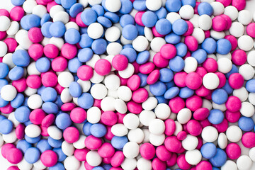 Chocolate dragee in a multi-colored glaze. Flat lay. Texture