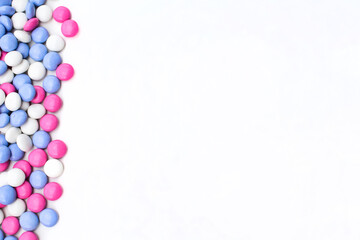 Chocolate dragee in a multi-colored glaze. Flat lay. Copy space
