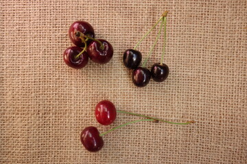 Sweet cherries, bitter cherries and sour cherries on burlap fabric
