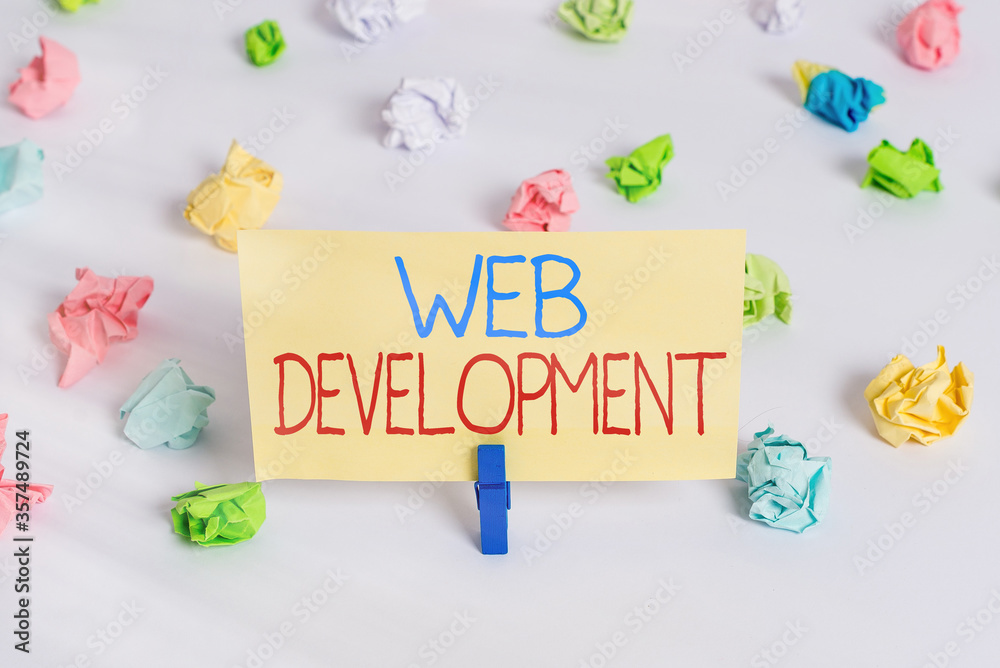 Fototapete Conceptual hand writing showing Web Development. Concept meaning work involved in developing a website for the Internet Colored crumpled paper empty reminder white floor clothespin