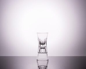 Fototapeta na wymiar empty glasses for strong alcoholic beverages on a gray gradient background