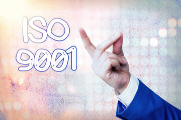 Writing note showing Iso 9001. Business concept for the appropriate international standard followed...
