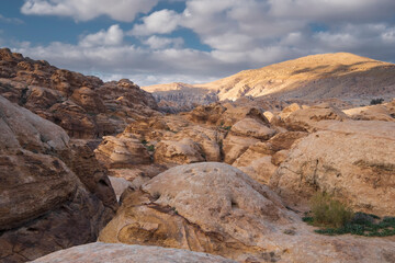 Fototapeta na wymiar cliffs of light limestone in the desert mountains near the city of Wadi Musa in the Petra National Park in Jordan