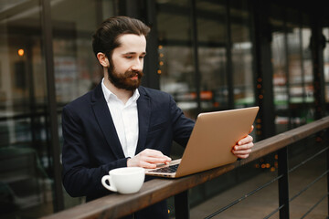 Handsome man in a black suit. Businessman working in a office