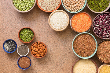 Collection of a various of legumes, beans, grains and seeds in bowls. Top view, flat lay