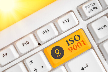Writing note showing Iso 9001. Business concept for the appropriate international standard followed...